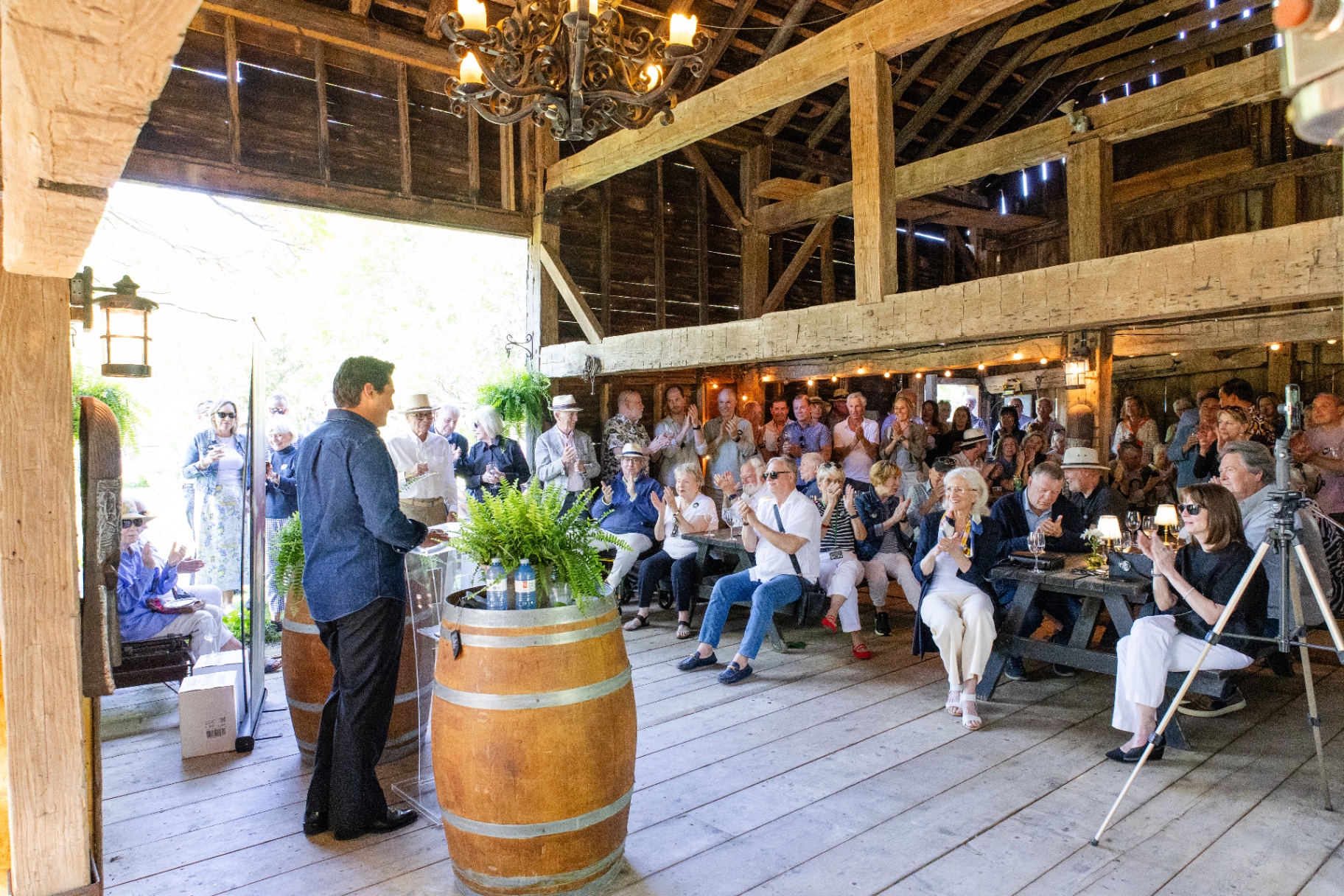 Weston Miller addressing supporters at a community campaign event in a historic Niagara-on-the-Lake barn